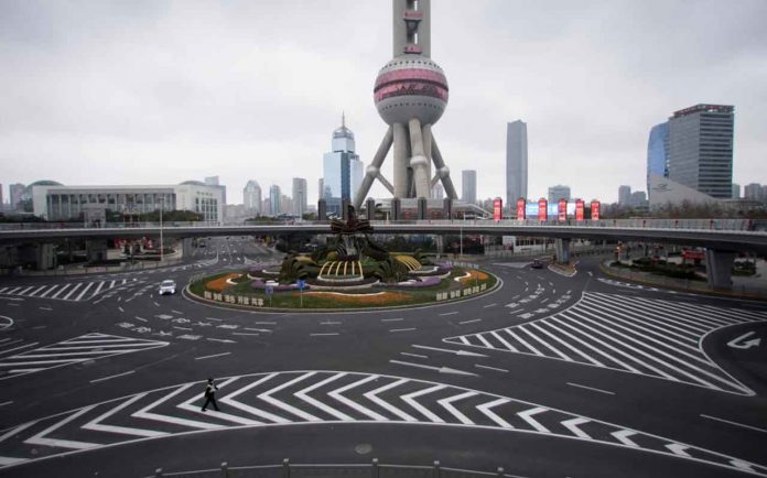 A police officer wears a mask as he walks in front of the Oriental Pearl Tower, as the country is hit by an outbreak of a new coronavirus, in Lujiazui financial district in Pudong, Shanghai, China, February 5, 2020. REUTERS/Aly Song