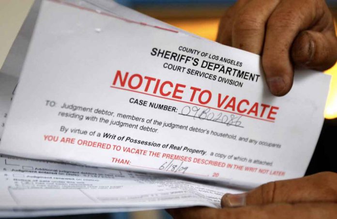 ARCHIVE PHOTO: A man holds up his eviction notice in Los Angeles, June 11, 2009. REUTERS/Lucy Nicholson