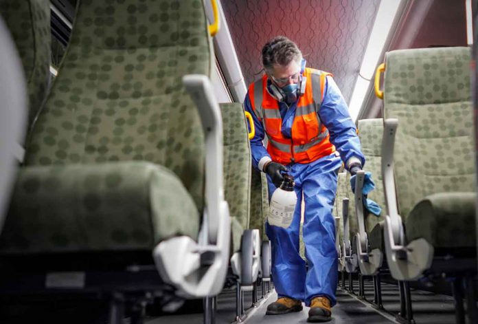 A crew member cleans a GO bus. At least 40 buses are being specially cleaned each day. (Metrolinx photo)