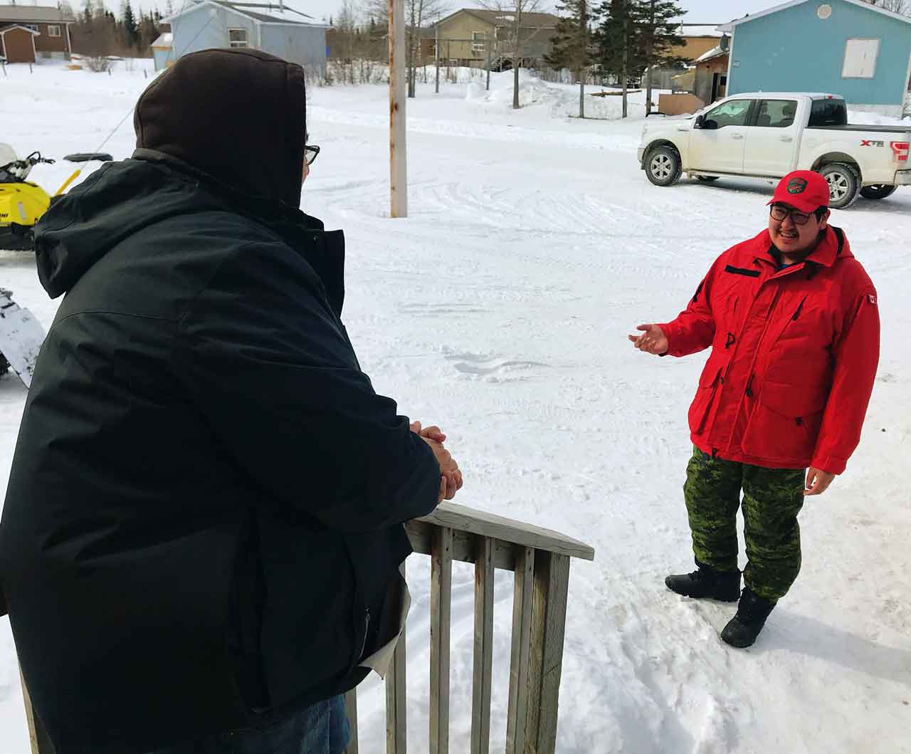 Ranger Joseph Hunter conducts a wellness check with a resident of Peawanuck. Photo credit: Master Corporal Jason Hunter, Canadian Rangers