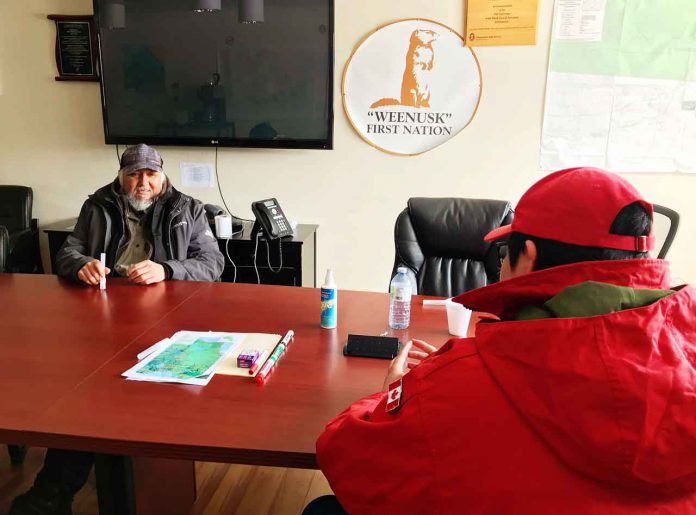 Peawanuck Chief Abraham Hunder talks with Ranger Joseph Hunter about the Covid-19 situation. photo credit: Master Corporal Jason Hunter, Canadian Rangers