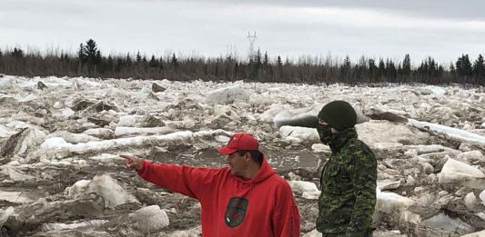 Master Corporal Joe Lazarus, left, shows Corporal Randy Jones, a visiting soldier what to look for as the Albany River breaks up.