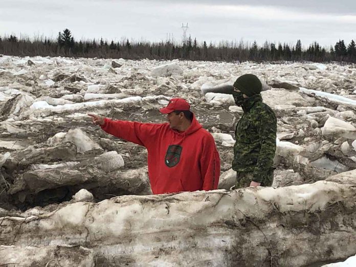 Master Corporal Joe Lazarus, left, shows Corporal Randy Jones, a visiting soldier what to look for as the Albany River breaks up.