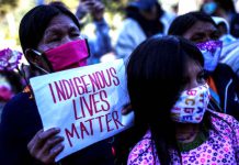 Colombians demand tough punishments in rape of indigenous girl FILE PHOTO: Demonstrators wearing face masks protest in front of a military battalion, against the reported rape of an Embera Chami indigenous girl by soldiers, in Bogota, Colombia June 29, 2020. REUTERS/Luisa Gonzalez/File Photo