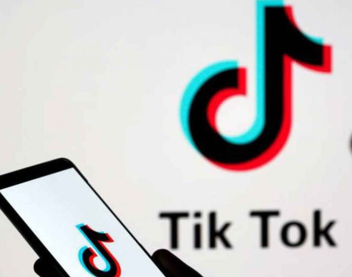 A person holds a smartphone with Tik Tok logo displayed in this picture illustration taken November 7, 2019. Picture taken November 7, 2019. REUTERS/Dado Ruvic/Illustration