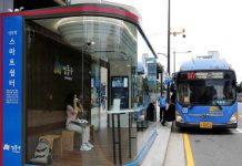 Partnership for Healthy Cities: Tedros Ghebreyesus, Mike Bloomberg, José Luis Castro and Mayors of Chicago and Montevideo to discuss how cities are prioritizing equity in COVID-19 A woman wears a mask inside a glass-covered bus stop in which a thermal imaging camera, UV sterilizer, air conditioner, CCTV and digital signage are set, to avoid the spread of COVID-19 in Seoul, South Korea, August 14, 2020. REUTERS/Heo Ran