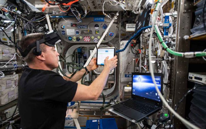 Expedition 63 Commander Chris Cassidy during the preparation of the Vection experiment. Credits: NASA