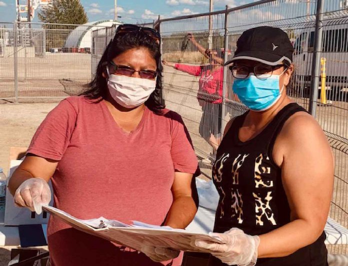 Master Corporal Karen Meeseetawageesic, left, works with Wanda Sugarhead, an Eabametoong band councillor, in preparing lists of the sick and vulnerable to who need to be evacuated on a priority basis to escape the forest fire. -Credit Canadian Rangers