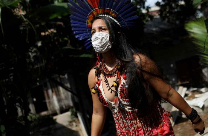 Samela Satere-Mawe, a 24-year-old biology student and Indigenous activist walks near her home, which is also the headquarters of the Satere Mawe WomenÕs Association in the Compensa neighborhood in Manaus, Amazonas state, Brazil, October 2, 2020. REUTERS/Bruno Kelly