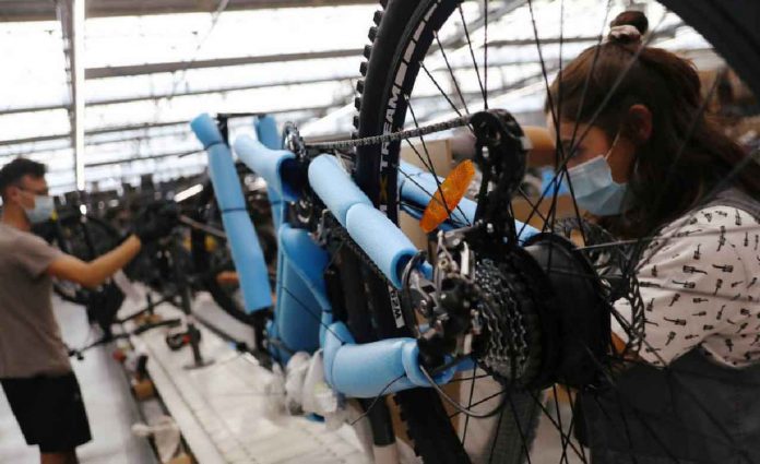 Workers are seen in InCycles bicycles factory in Anadia, Portugal, September 25, 2020. REUTERS/Pedro Nunes