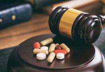 Impaired-by-Drugs-judge-gavel-and-drugs-on-a-wooden-desk-P3KL95T