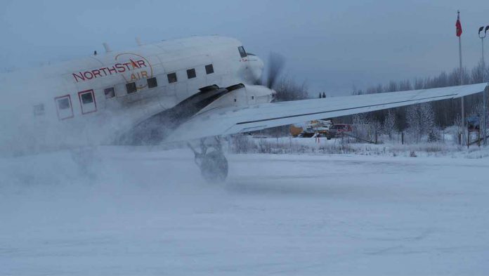The light dusting of snow gets airborne in Pikangikum as the North Star Air Basler BT-67 lands.