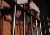 What Happens Between an Arrest and a Bail Hearing in Ontario? man behind bars in jail