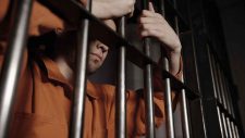 man-in-jail-behind-bars-for-a-crime_t20_JaapRP
