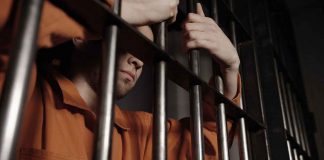 What Happens Between an Arrest and a Bail Hearing in Ontario? man behind bars in jail