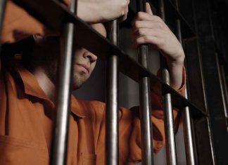 What Happens Between an Arrest and a Bail Hearing in Ontario? man behind bars in jail