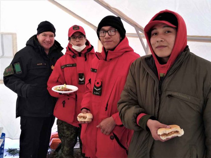 Taking a quick snack between Ranger duties are, from left, Petty Officer Second Class Kevin McCue, an instructor, Corporal Sandi Moose, Ranger Clayton Peters, and Corporal Eli Owens. credit: Canadian Rangers