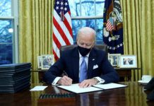 Biden Reopens Health Insurance Marketplace to Help Americans Who Lost Coverage U.S. President Joe Biden signs executive orders in the Oval Office of the White House in Washington, after his inauguration as the 46th President of the United States, U.S., January 20, 2021. REUTERS/Tom Brenner