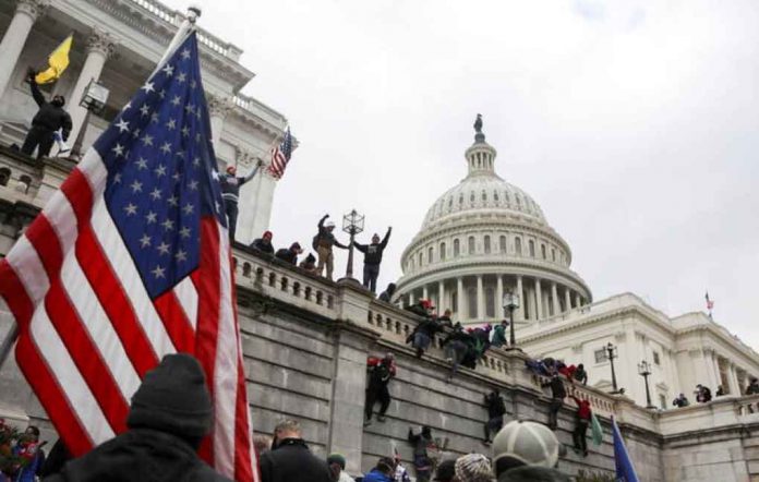 Supporters of U.S. President Donald Trump climb on walls at the U.S. Capitol during a protest against the certification of the 2020 U.S. presidential election results by the U.S. Congress, in Washington, U.S., January 6, 2021. REUTERS/Jim Urquhart