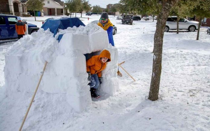Freak cold in Texas has scientists discussing whether climate change is to blame by Reuters Wednesday, 17 February 2021 20:11 GMT Brett Archibad helps his son build an Igloo as his son Avett Archibad ,8, peeks out of the Igloo in their front yard of their home in the BlackHawk neighborhood in Pflugerville, Texas, U.S. February 16, 2021. Picture taken February 16, 2021. Ricardo B. Brazziell/American-Statesman/USA Today Network via REUTERS. NO RESALES. NO ARCHIVES. MANDATORY CREDIT