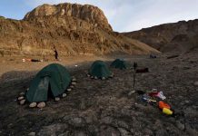 Time travel to a warm Arctic – Greenland Cave Expedition The expedition to Greenland was a challenge: After arriving by plane and boat, the team had to hike for three more days before they could set up their tents beneath the caves they were looking for. CREDIT Robbie Shone