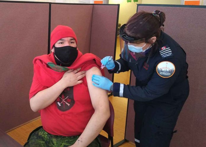 Master Corporal Sinclair Childforever of Fort Severn receives a COVID vaccination while assisting paramedics in the delivery of the vaccine in Sachigo Lake. credit PO2 Kevin McCue