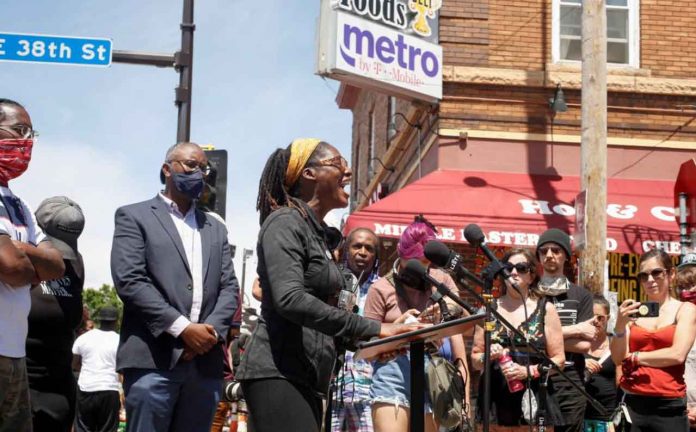 Marcia Howard addresses the media and community members after city employees began to reopen George Floyd Square, the area where George Floyd was killed in Minneapolis police custody the year before, in Minneapolis, Minnesota, U.S., June 3, 2021. REUTERS/Nicole Neri