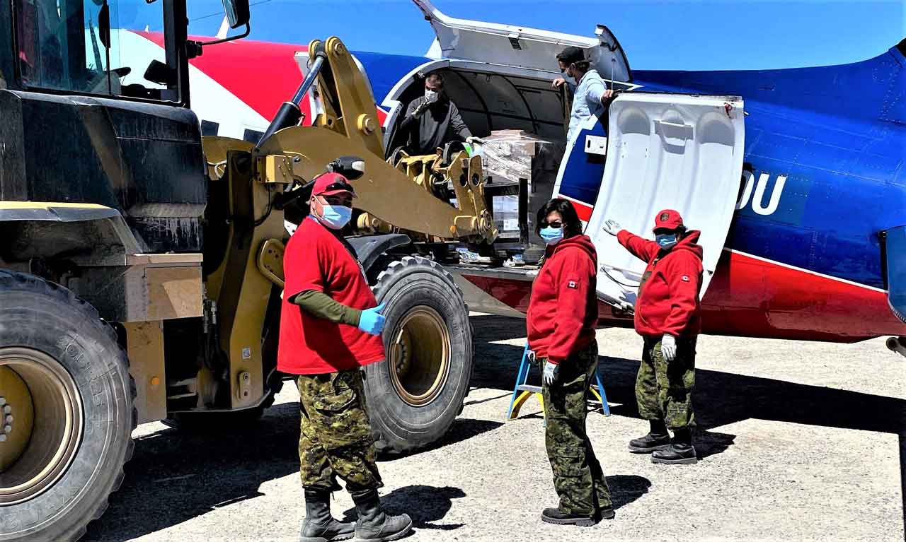 Canadian Rangers unload a cargo plane at Kashechewan airport. credit Sergeant Janet Butt, Canadian Rangers