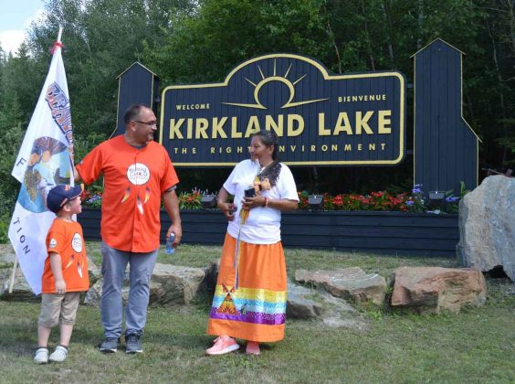 photo by Xavier Kataquapit - Warm greetings and well wishes were provided by Chief Wayne Wabie, Beaverhouse FN, and his grandson Dawson Moore to Walk Of Sorrow group leader Patricia Ballantyne (right) as they arrived in Kirkland Lake.