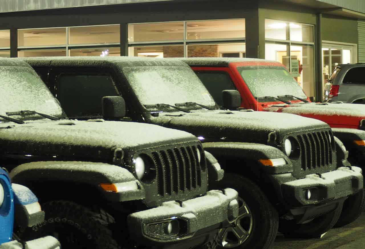 Light snow on Jeeps at Lakehead Motors on Memorial Avenue in Thunder Bay