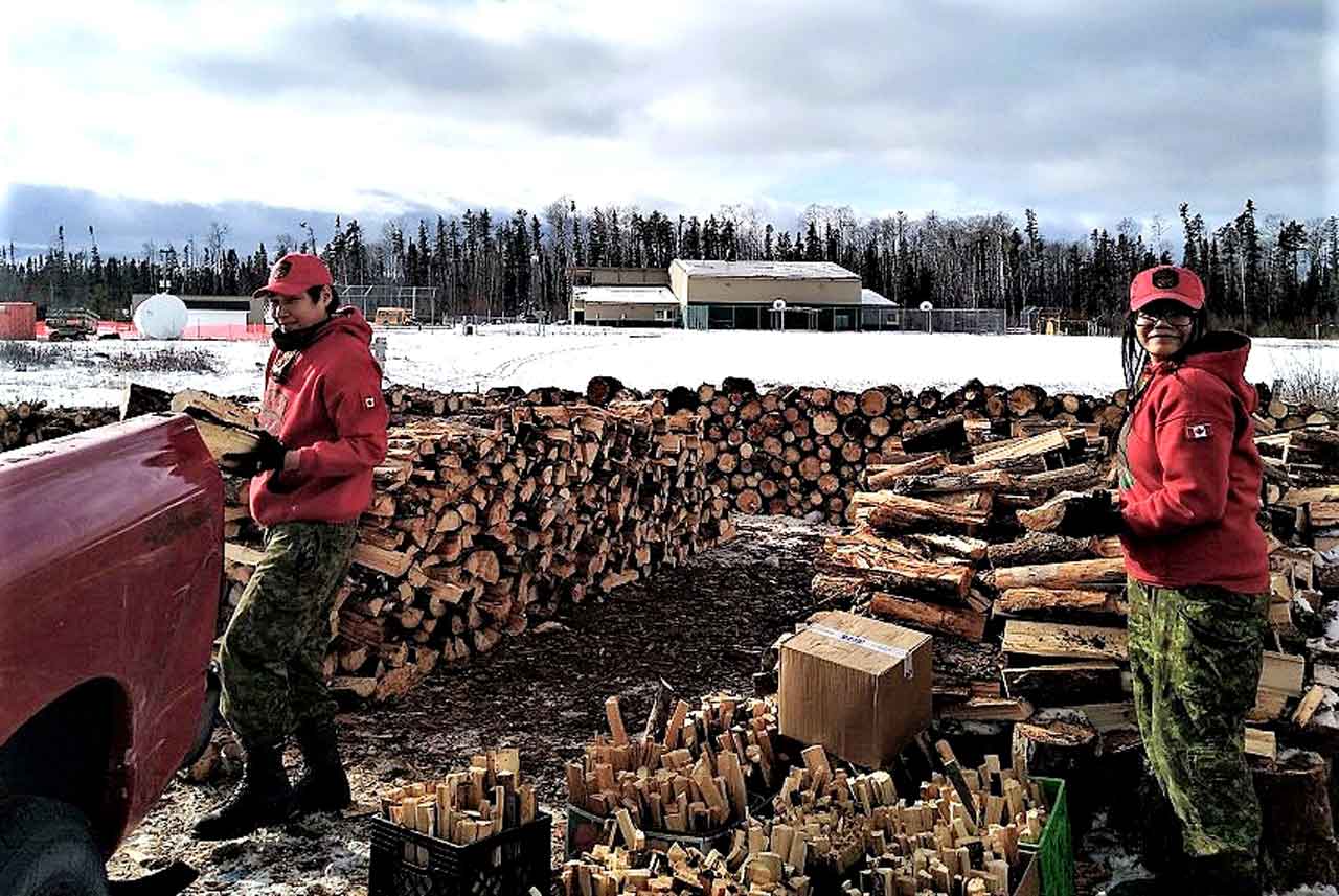 Rangers cut wood for elders who remained in Neskantaga  when most of the First Nation community evacuated during a drinking water supply crisis.