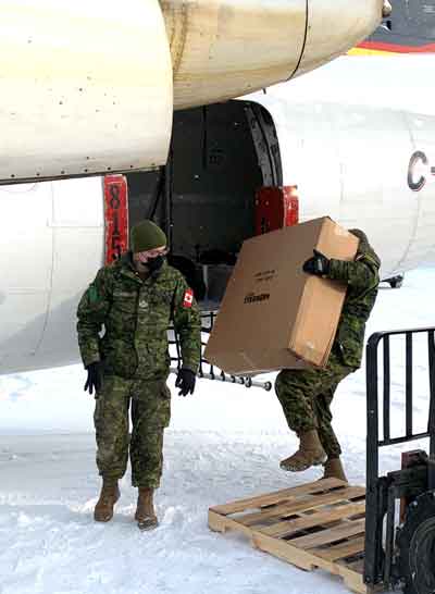 Soldiers load supplies onto an aircraft at Pickle Lake airport. Credit Major Tom Bell, Canadian Army