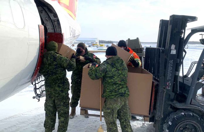 Soldiers load supplies onto an aircraft at Pickle Lake airport. Credit Major Tom Bell, Canadian Army