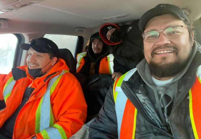 photo submitted by Paul Kataquapit A day of winter ice road construction with his crew is Paul Kataquapit (front right) with his nephews Willie Wesley (front left), Joshua Kataquapit (back left) and Jonah Kataquapit (back right).