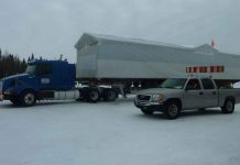 Ontario Boosts Winter Roads Funding to $13 Million to Connect Remote First Nations and Northern Communities photo by Lawrence Rose Winter ice road building also includes transporting of goods and material. Pictured is a transport owned by Kataquapit Freight Services hauling a prefabricated building destined for Attawapiskat First Nation.