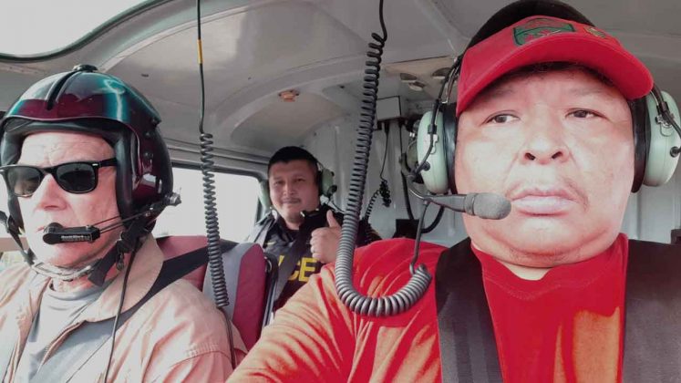 Pilot Chad Paettin, left, flies an OPP rescue helicopter with passengers Constable Darryl Sainnawap, centre, and Ranger Sergeant Spencer Anderson, right, to missing fisherman's camp. credit Sergeant Spencer Anderson, Canadian Rangers