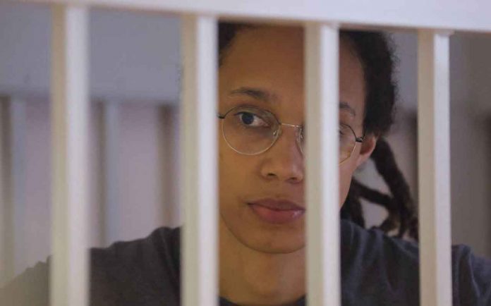 U.S. basketball player Brittney Griner, who was detained at Moscow's Sheremetyevo airport and later charged with illegal possession of cannabis, stands inside a defendants' cage during the reading of the court's verdict in Khimki outside Moscow, Russia August 4, 2022. REUTERS/Evgenia Novozhenina