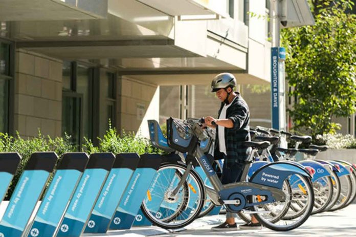 A Mobi user starts an e-bike trip at a Mobi e-station.