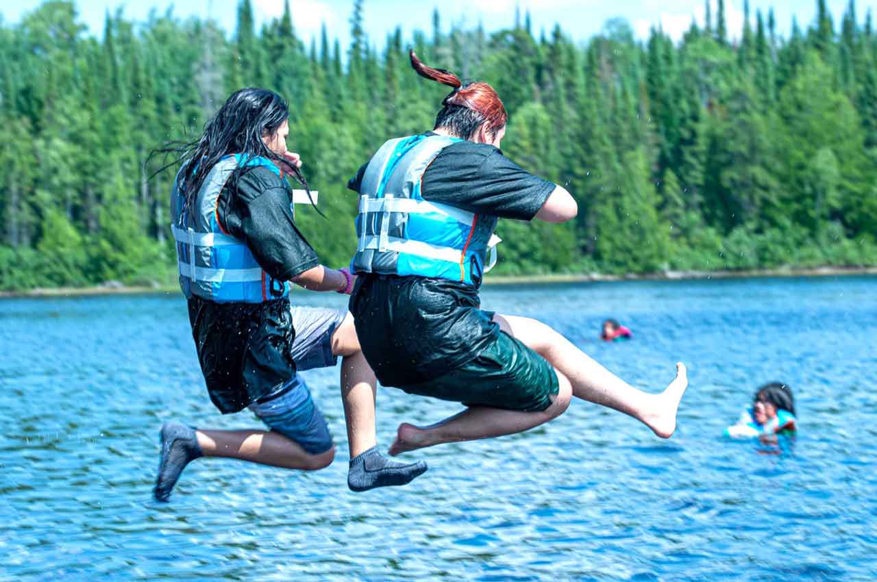 Junior Canadian Rangers jump into a lake to cool off on a hot day. credit Canadian Rangers