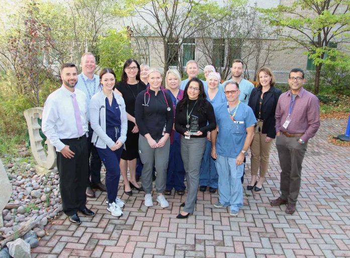 Members of TBRHSC's leadership team, along with staff and physicians from the Intensive Care Unit, Operating Room and TGLN (Ontario Health) gather in the Hospital's Garden of Life to accept the award.