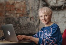 How Emergency Alert Systems Help Seniors Live Independently And Safely Elderly woman on laptop