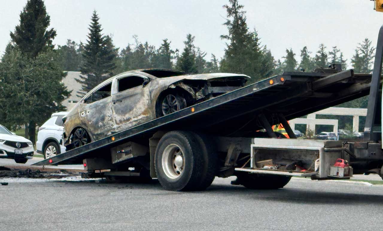 Burnt vehicle being loaded on tow truck