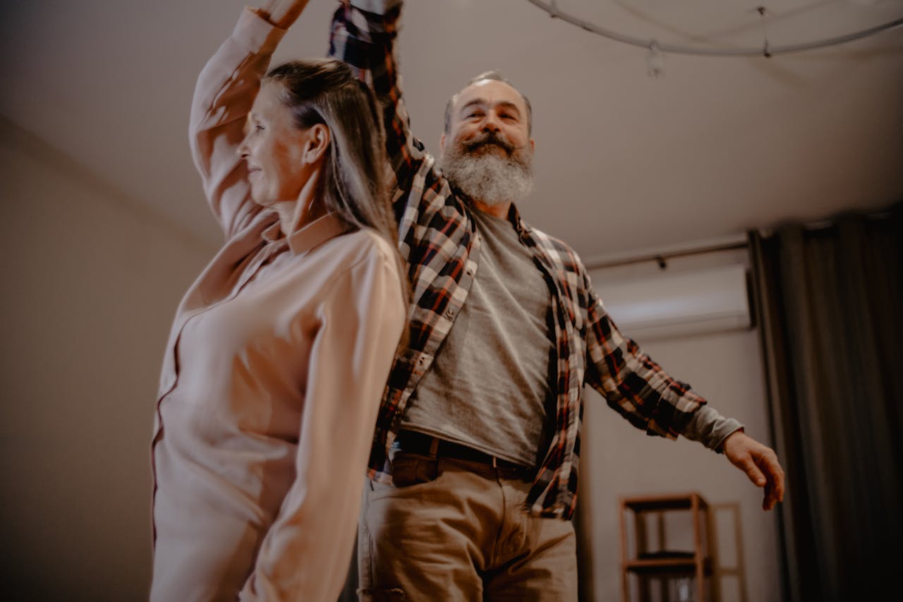Photo by Mikhail Nilov: https://www.pexels.com/photo/an-elderly-couple-dancing-in-a-living-room-6972759/