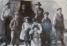 Under The Northern Sky ‘Attawapiskat First Nation Election 2025’ photo supplied by Kataquapit family This faded historical photo features my grandfather James Kataquapit who was Chief of Attawapiskat in 1945. Here we see him standing with a hat and pin signifying his leadership. His wife Janie Kataquapit is standing at the door. Chief Kataquapit was also a veteran of the First World War. From L-R are his children: Thomas, Marius, Celine, David, Gabriel and Alex. Missing are brothers George and Leo.