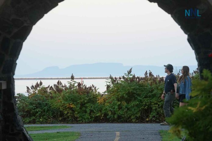 Marina-Park-Sleeping-Giant-Archway-Sept-2025-DSC02589 Couple walking at Marina Park with Sleeping Giant in background