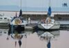 Electric vs. Gas Outboard for a Yacht Tender: An Honest Breakdown for Coastal Cruisers Two sailboats docked Marina Park Sept 2025