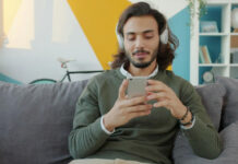 How Mobile Design Influences iGaming Architecture man on mobile