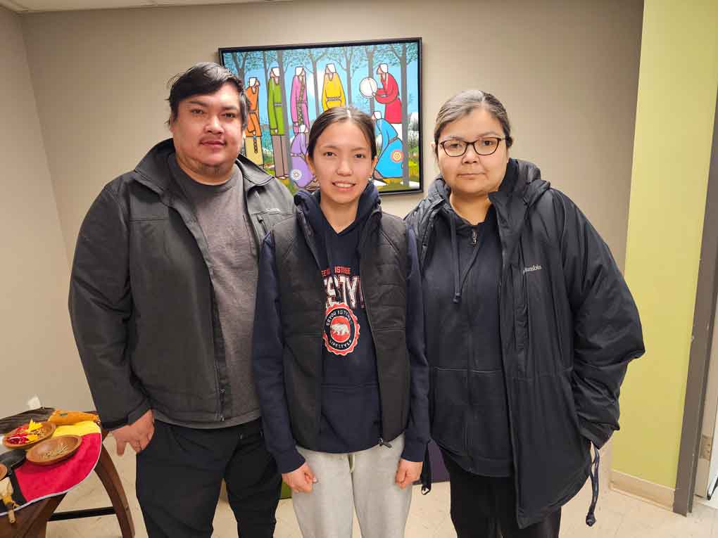 photo by X KataquapitNeveah Koostachin was one of the youngest players at 16 years of age to be part of the Attawapiskat FN Womens Team during the Rupert River Cup Tournament which was held in Waskaganish from March 5 to 8, 2026. She is pictured here with her parents Trevor Koostachin and Rita Shisheesh.