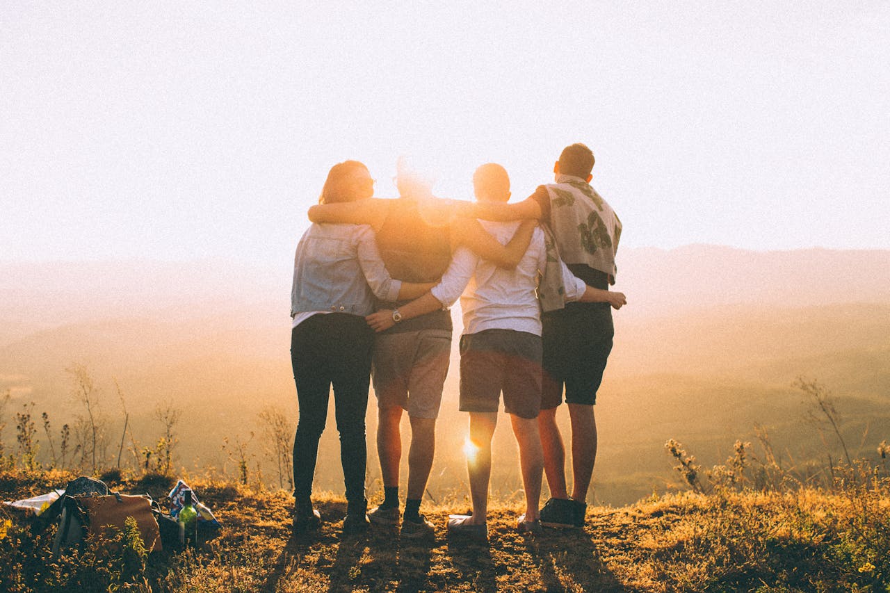 Photo by Helena Lopes: https://www.pexels.com/photo/four-person-standing-on-cliff-in-front-of-sun-697243/