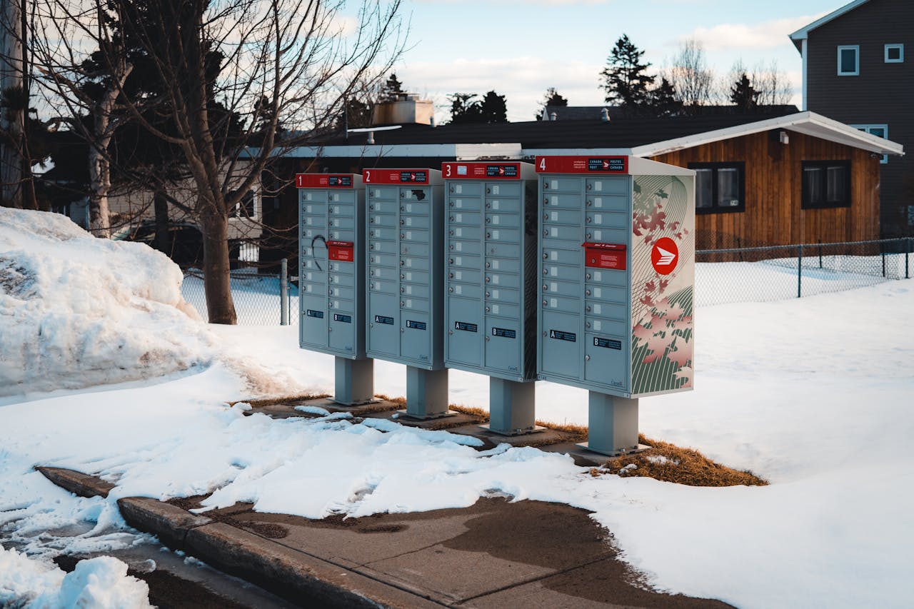 A rural Canadian mailbox receiving an online delivery in winter